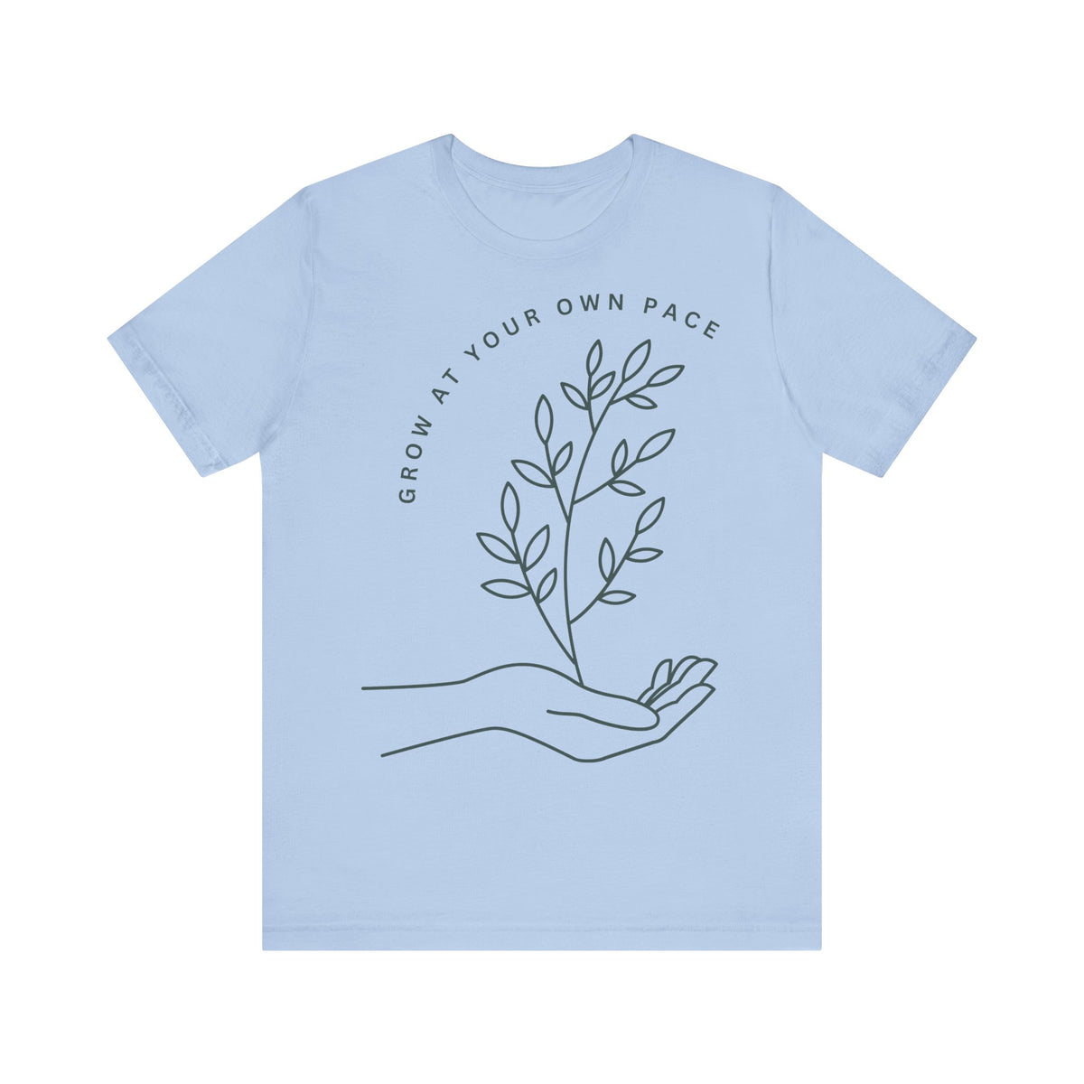 Minimal botanical print T-shirt with "Grow At Your Own Pace" slogan, featuring green leafy design on soft fabric.