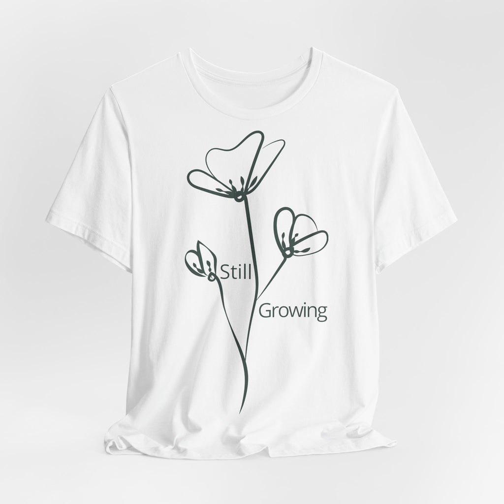 Still Growing Floral T-Shirt by Printify featuring minimalist floral design and inspirational text, casual unisex tee.