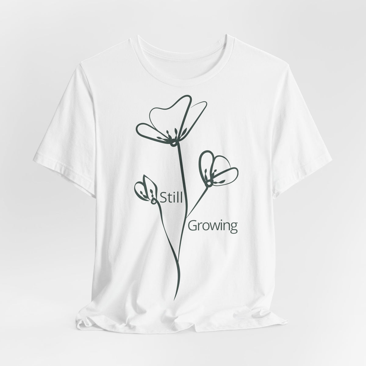 Still Growing Floral T-Shirt by Printify featuring minimalist floral design and inspirational text, casual unisex tee.