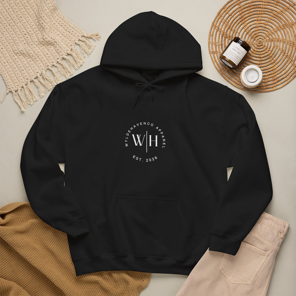 Black hoodie featuring a monogram circle design and WyldeHaven Apparel Est. 2026 logo on the front, made by Printify.