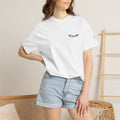 Black "One of a Kind" Chest Logo T-shirt by Printify featuring a front chest logo design on soft cotton fabric.