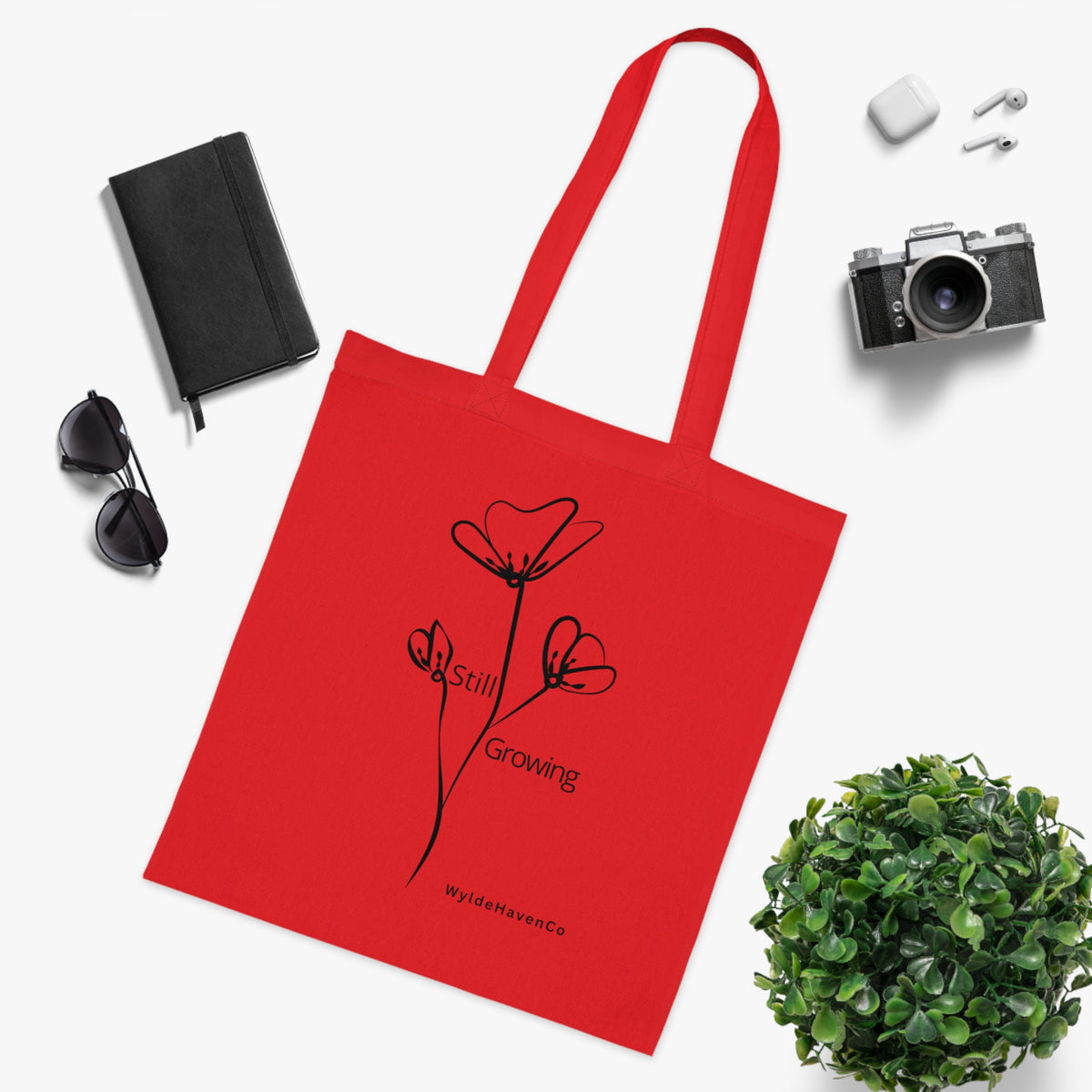 Still Growing floral cotton tote bag by Printify with minimalist design, featuring colorful floral pattern on natural fabric background.