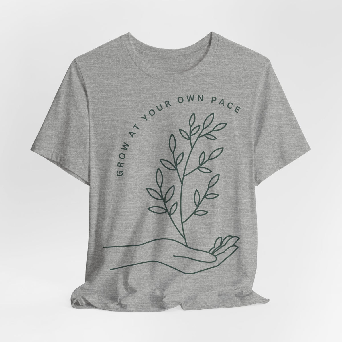 Minimal botanical print T-Shirt by Printify featuring "Grow At Your Own Pace" slogan on soft fabric.