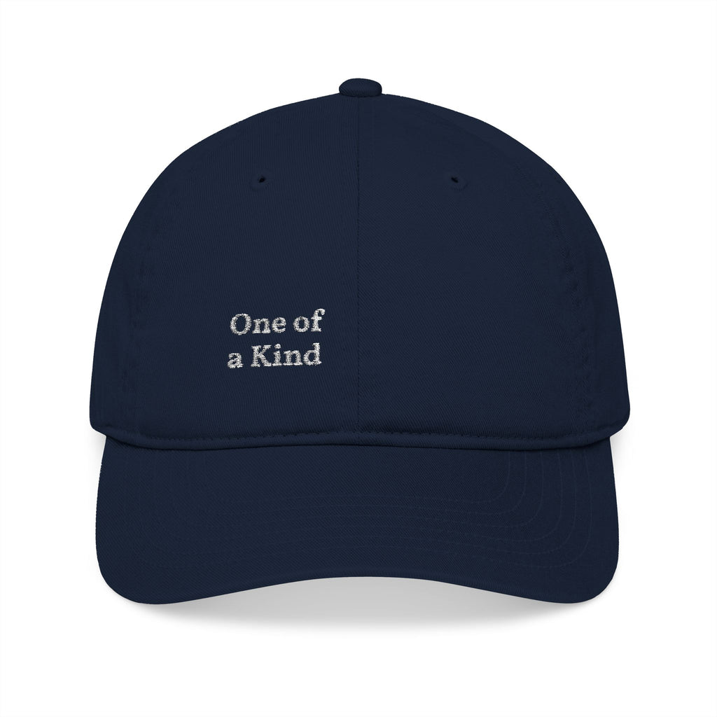 Organic embroidered baseball cap with "One of a Kind" design, casual style, featuring minimal embroidery and adjustable strap.