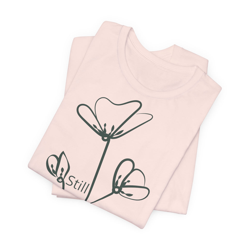 Still Growing floral print T-shirt by Printify featuring minimalist inspirational design on soft fabric.