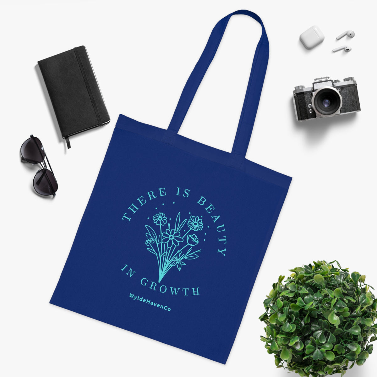Floral cotton tote bag with inspirational message, eco-friendly design by Printify, featuring colorful flower illustrations.