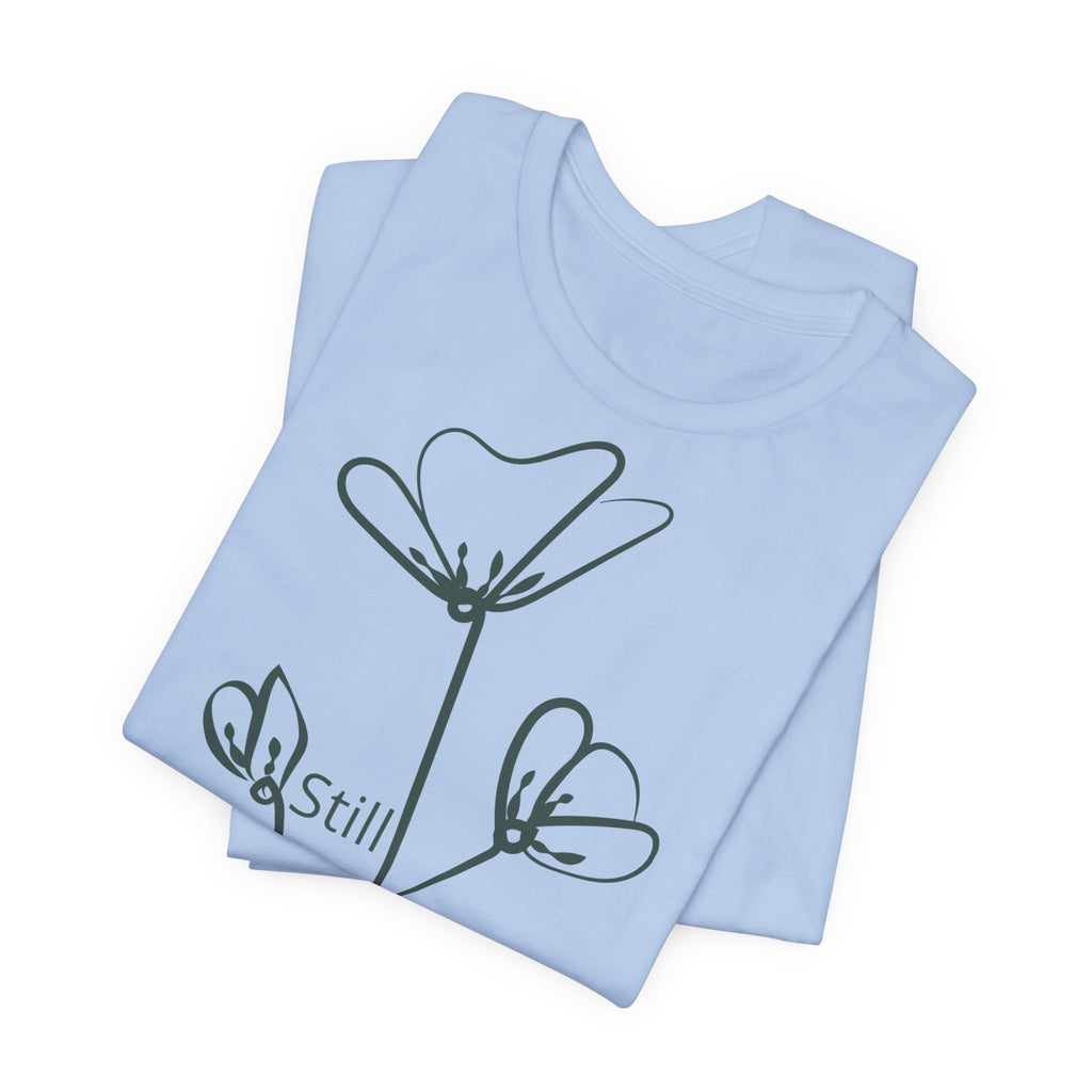Still Growing floral print minimalist T-shirt by Printify, featuring a simple inspiring design on a casual cotton tee.