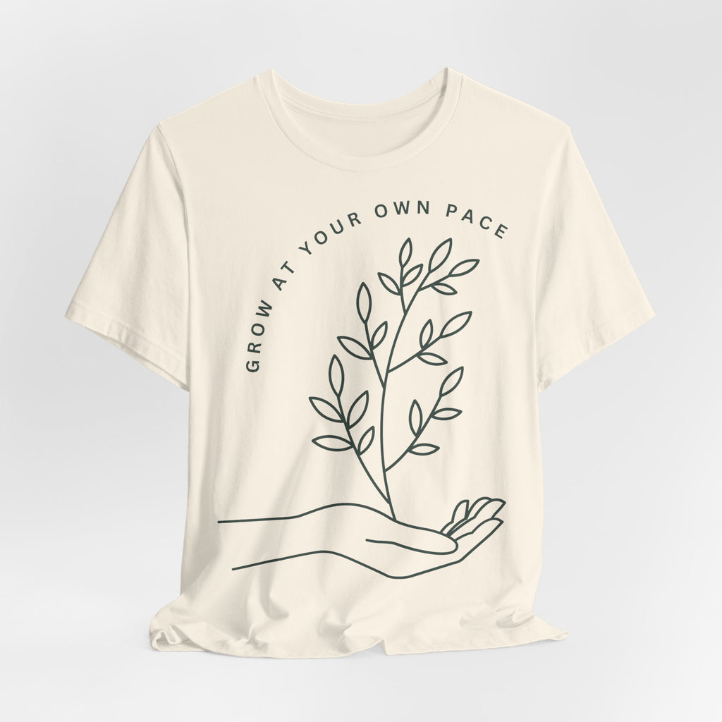Minimal botanical print T-shirt with "Grow At Your Own Pace" slogan, designed by Printify, casual and stylish graphic tee.