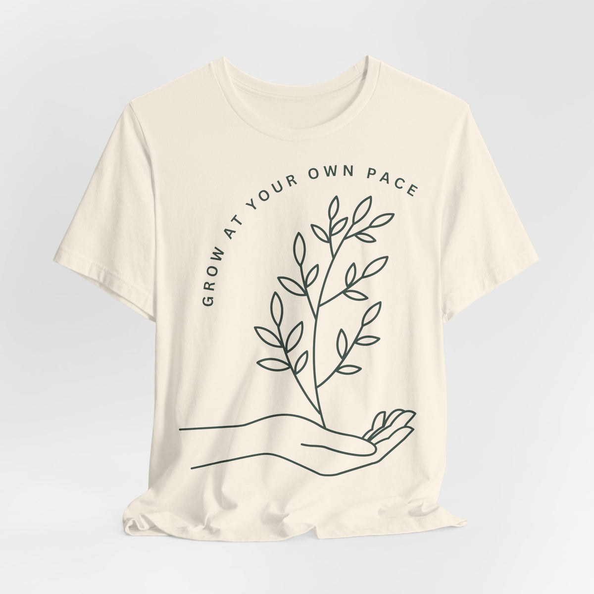 Minimal botanical print T-shirt with "Grow At Your Own Pace" slogan, designed by Printify, casual and stylish graphic tee.