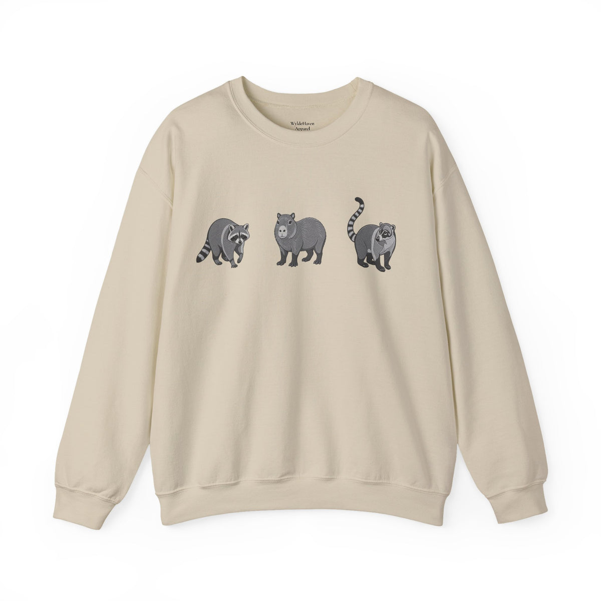 Wildlife Trio graphic sweatshirt featuring raccoon, capybara, and coati illustrations from Wyldelife Collection by Printify.