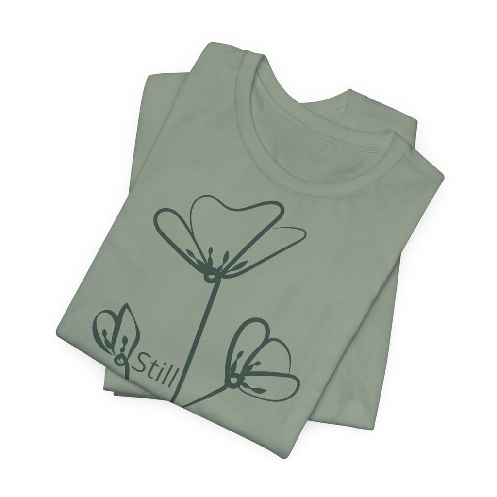 Still Growing floral T-shirt by Printify featuring a minimalist inspirational design, showcasing a stylish and comfortable T-shirt.