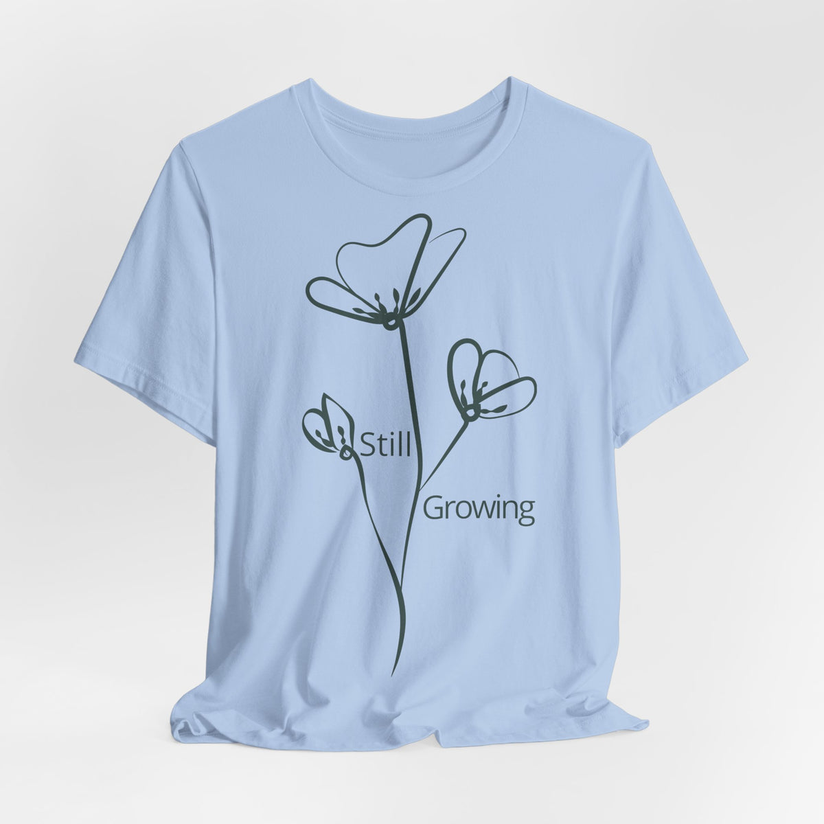Still Growing Floral T-Shirt by Printify, minimalist inspirational tee with floral design, casual everyday wear for women and men.