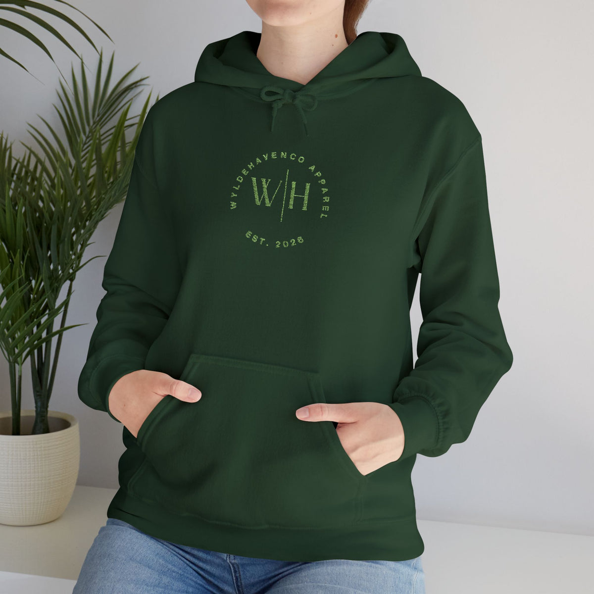 Green WyldeHaven logo embroidered hoodie by Printify, featuring a front embroidered emblem and a cozy, casual fit.