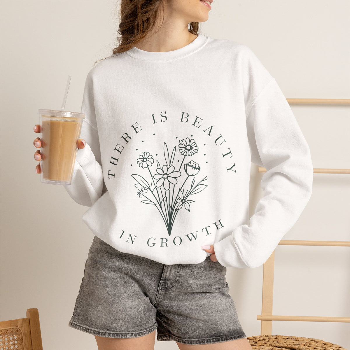 Cream-colored crewneck sweatshirt with "There Is Beauty in Growth" floral minimalist design by Printify, soft fabric and comfortable fit.