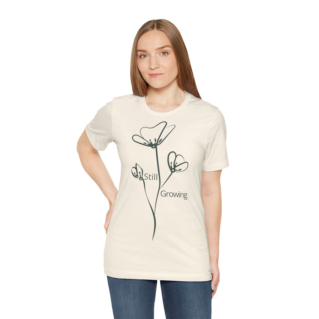 Still Growing floral T-shirt by Printify featuring a minimalist inspirational design on soft fabric, perfect for casual wear.