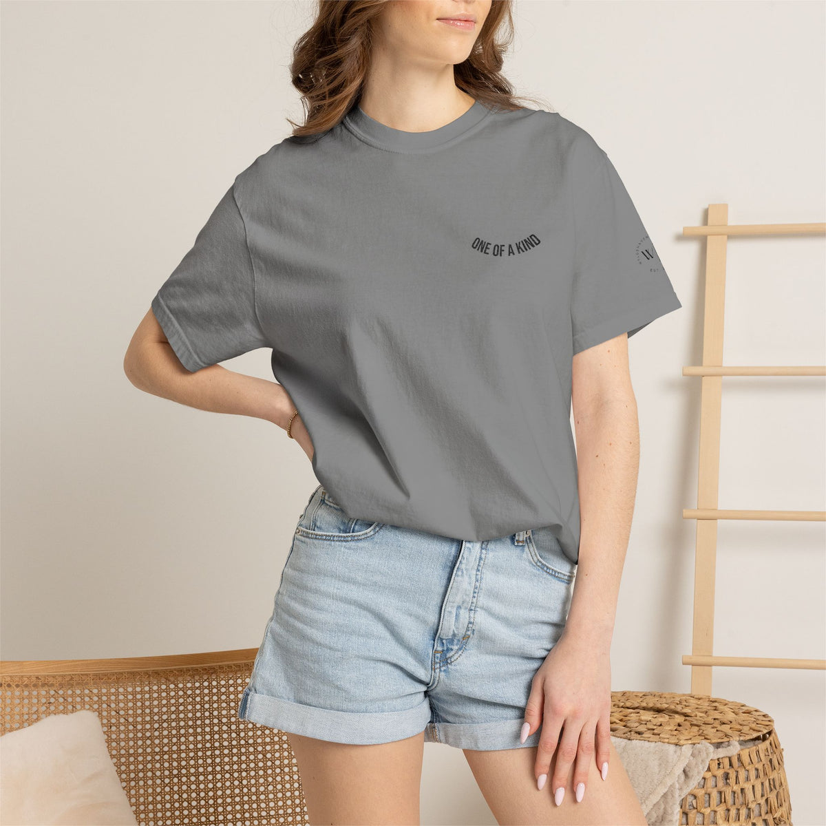 Black "One of a Kind" chest logo T-shirt by Printify featuring a minimalist design on soft cotton fabric.