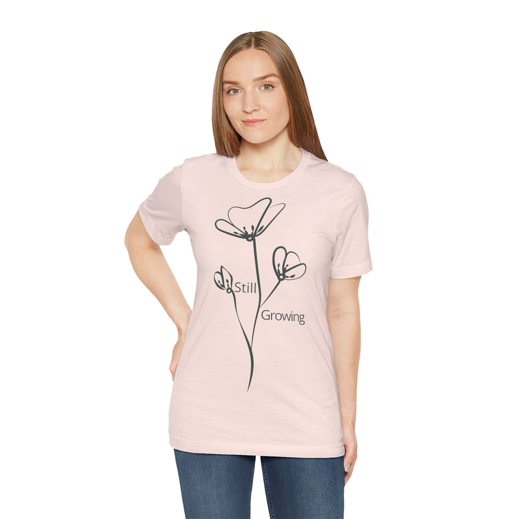 Still Growing floral T-shirt by Printify featuring a minimalist inspirational design, with a vibrant floral graphic on soft fabric.