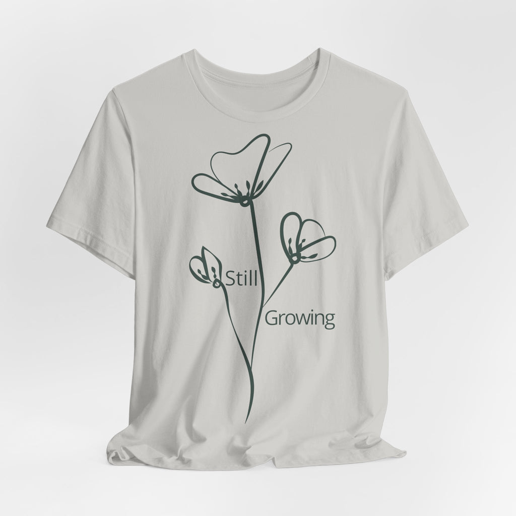 Still Growing Floral T-Shirt by Printify, minimalist inspirational tee with colorful floral design on soft fabric.