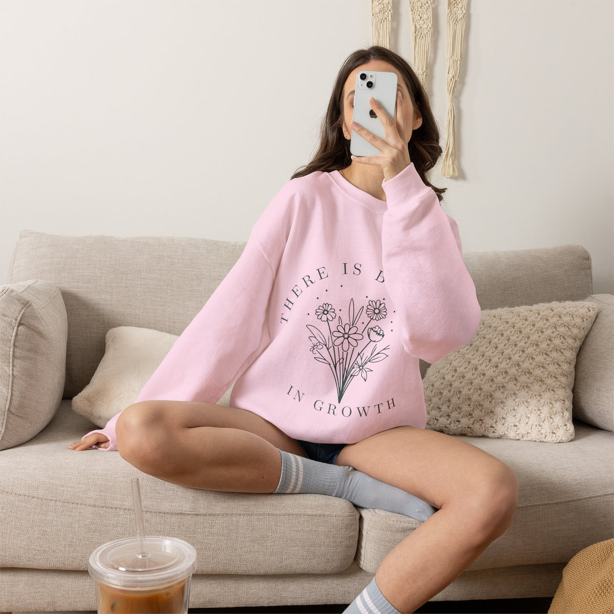 Printify crewneck sweatshirt featuring a minimalist floral design and the phrase "There Is Beauty in Growth" on the front.