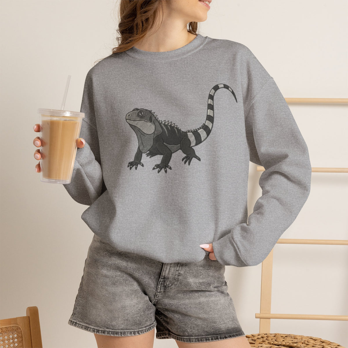 Gray sweatshirt featuring a colorful iguana graphic from the Wyldelife Collection by Printify, showcasing wildlife art.