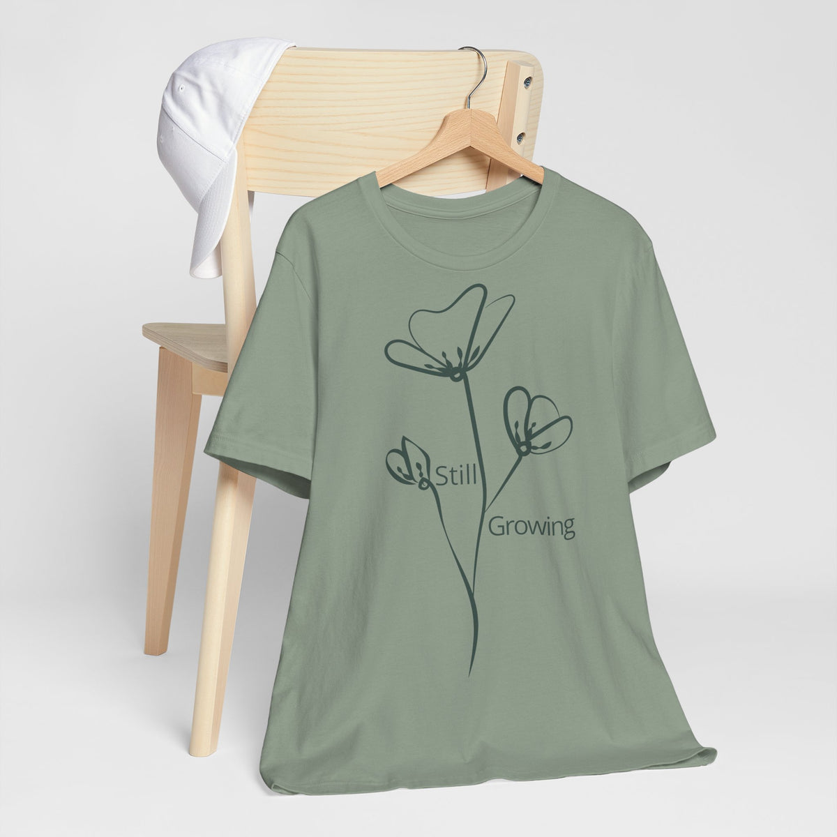 Still Growing Floral Tee by Printify, a minimalist inspired T-shirt featuring a floral design on soft fabric.