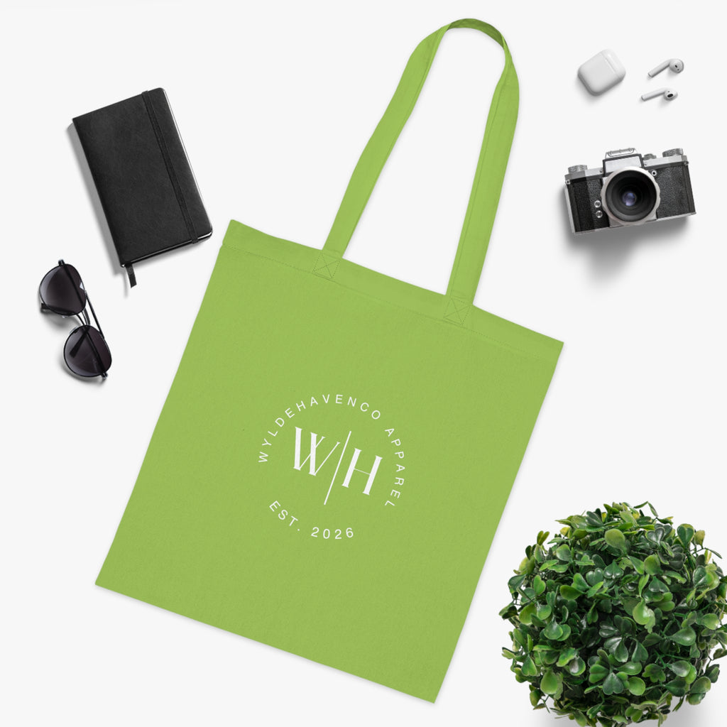 White cotton tote bag with a circular monogram print and WH logo, featuring durable canvas handles and spacious interior.