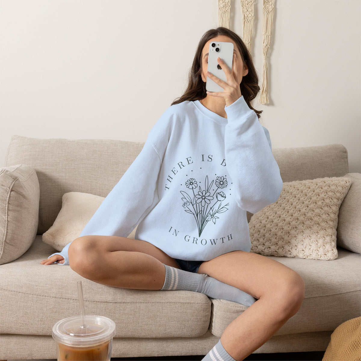 Light grey crewneck sweatshirt with floral minimalist design and the phrase "There Is Beauty in Growth" printed on the front.