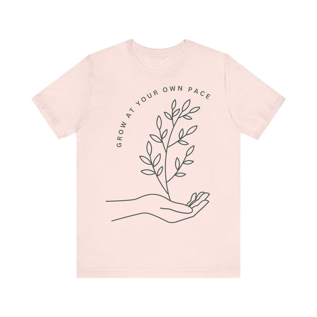 Minimal botanical print T-shirt by Printify featuring "Grow At Your Own Pace" text on a soft fabric tee.