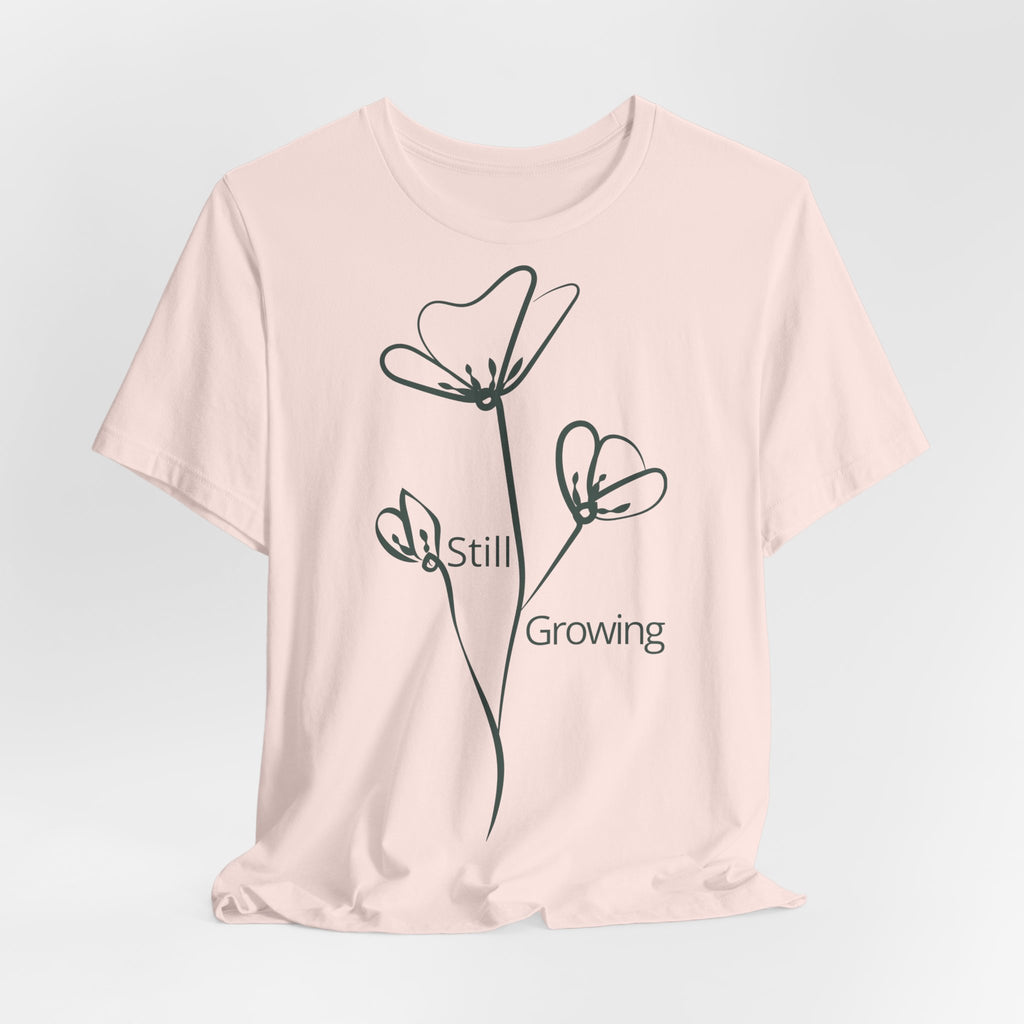Still Growing Floral T-Shirt by Printify, minimalist inspirational tee featuring a delicate floral design on soft fabric.