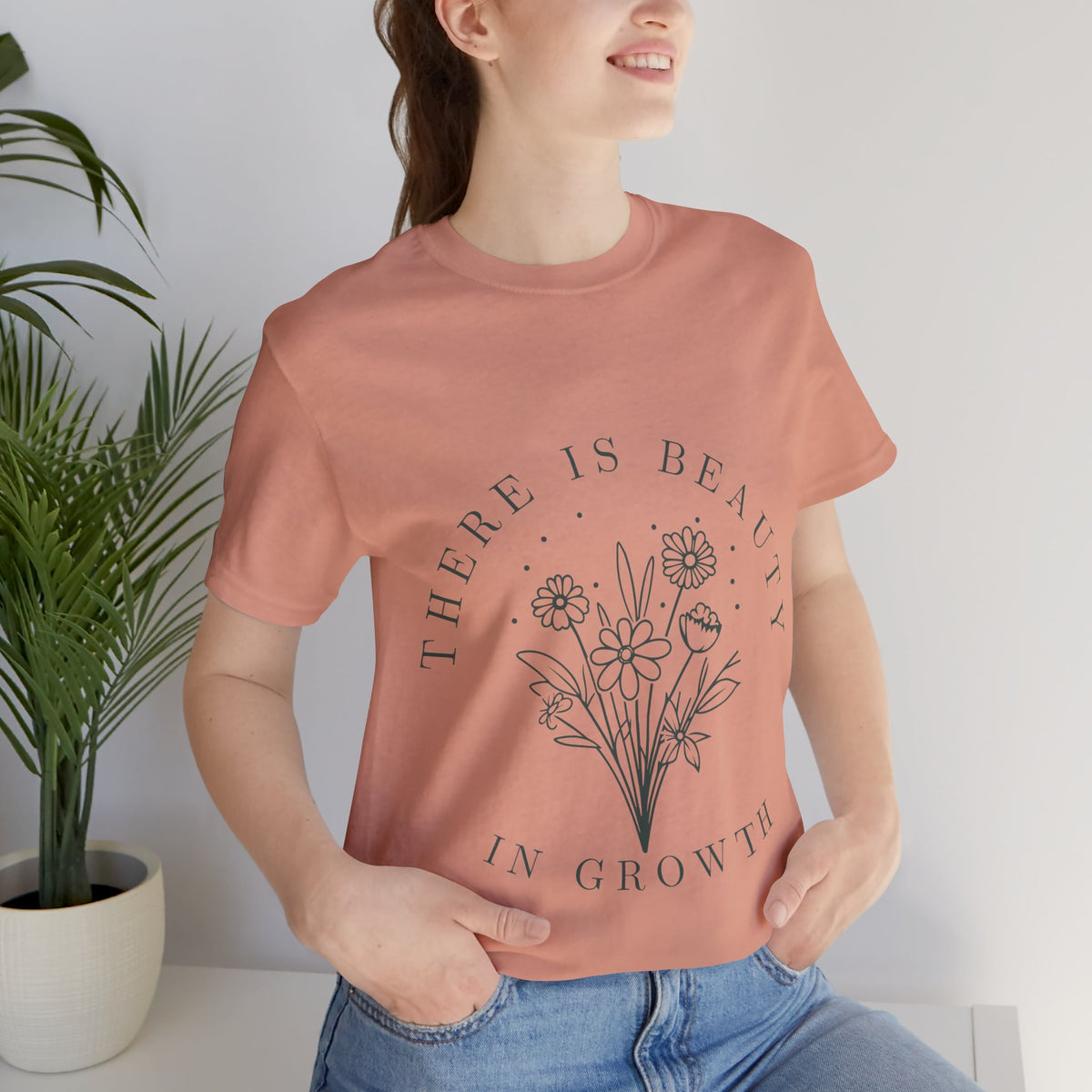 Printify floral T-shirt featuring a "There Is Beauty In Growth" design, with colorful floral artwork on a comfortable cotton tee.