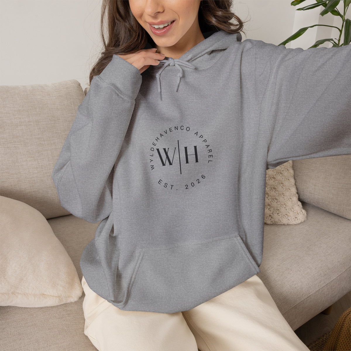 Black Monogram Circle hoodie by WyldeHaven Apparel featuring Est. 2026 logo, made by Printify, shown on a model.