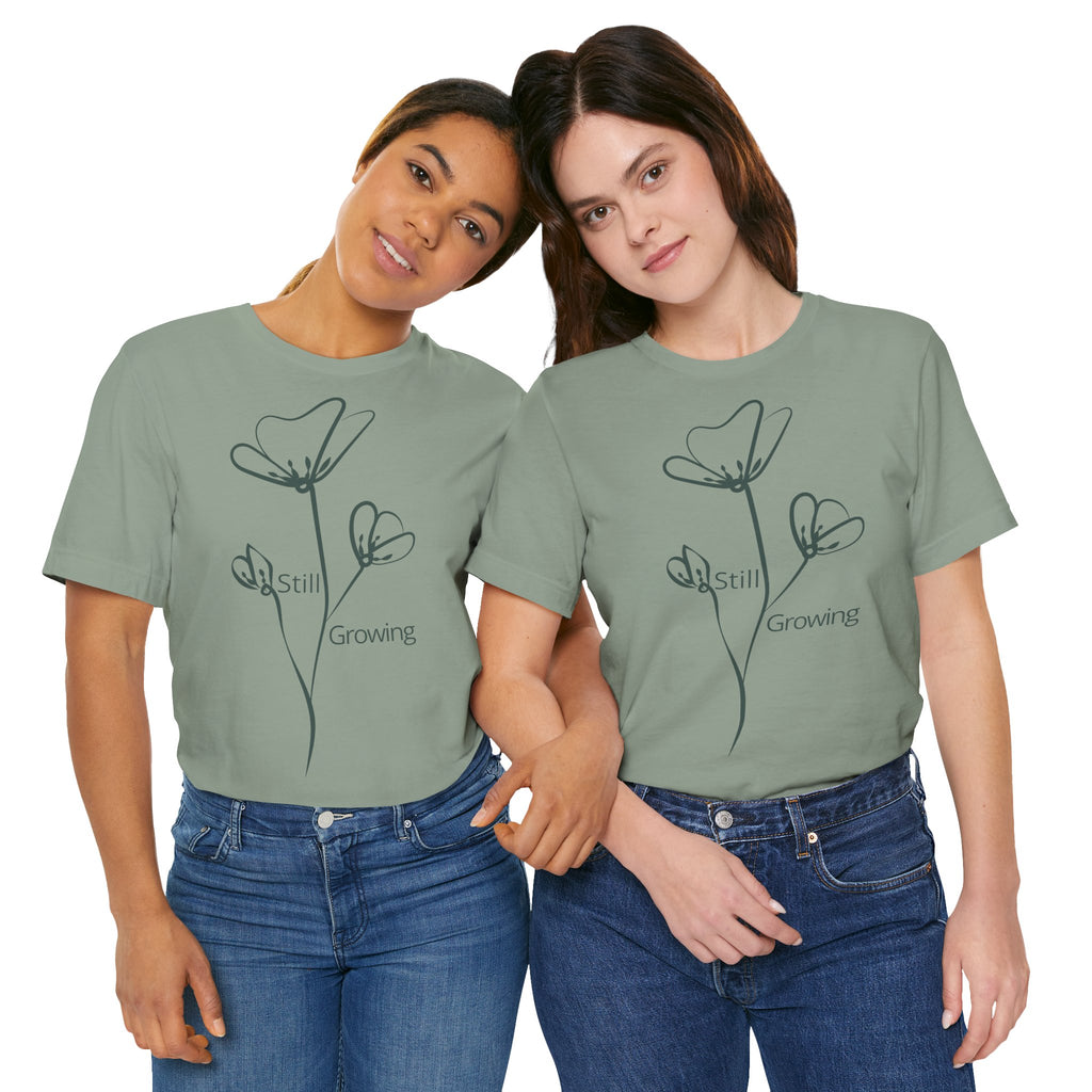 Still Growing Floral T-Shirt by Printify featuring minimalist floral design on a casual, inspirational graphic tee.