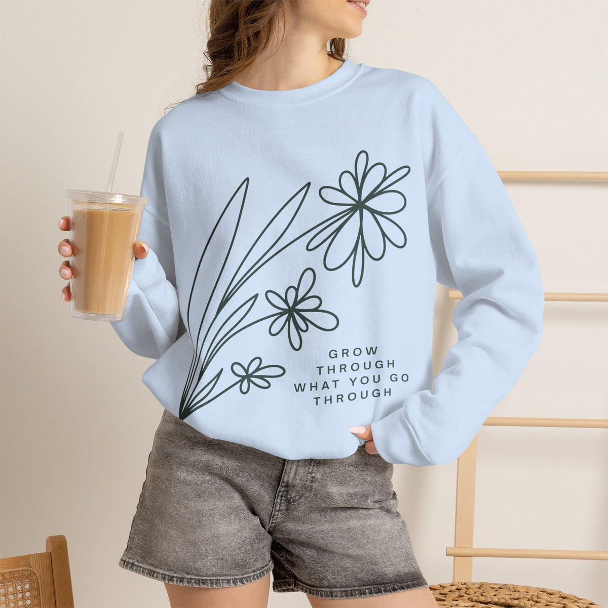 Printify crewneck sweatshirt with floral design and inspirational quote "Grow Through What You Go Through" on soft, comfortable fabric.