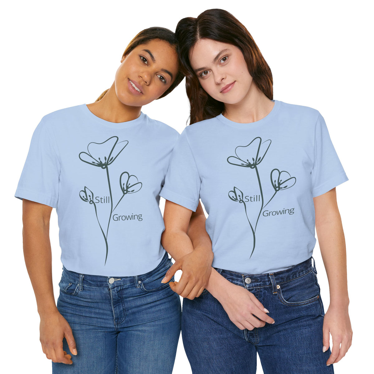 Still Growing Floral T-Shirt by Printify featuring a minimalist floral design and inspirational quote on a casual tee.