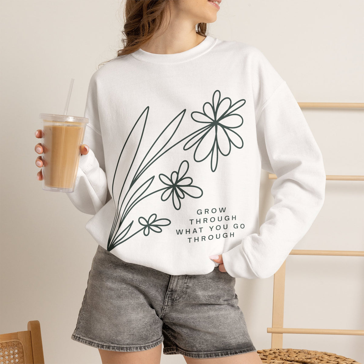Printify crewneck sweatshirt with floral design and motivational quote 'Grow Through What You Go Through' in soft, comfortable fabric.
