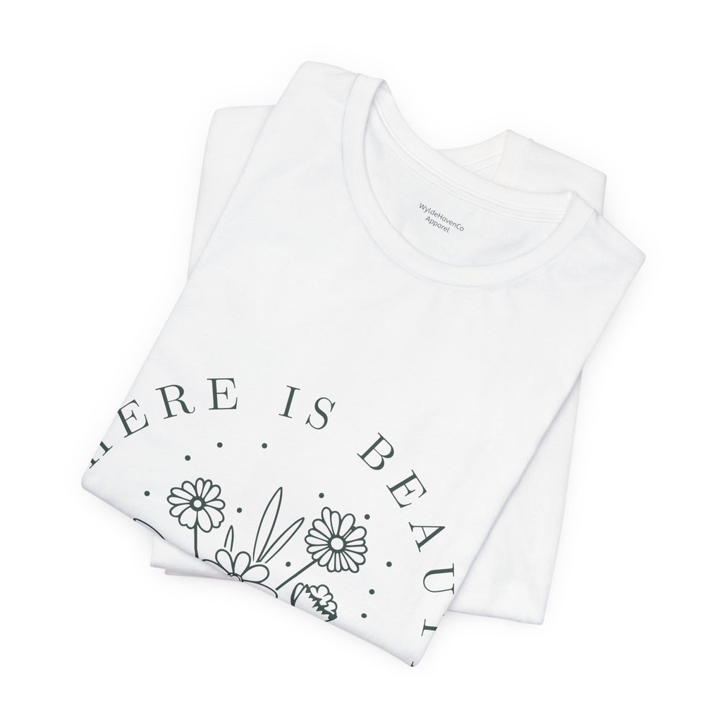 Printify floral T-shirt featuring "There Is Beauty In Growth" text, vibrant botanical design on a casual cotton tee.