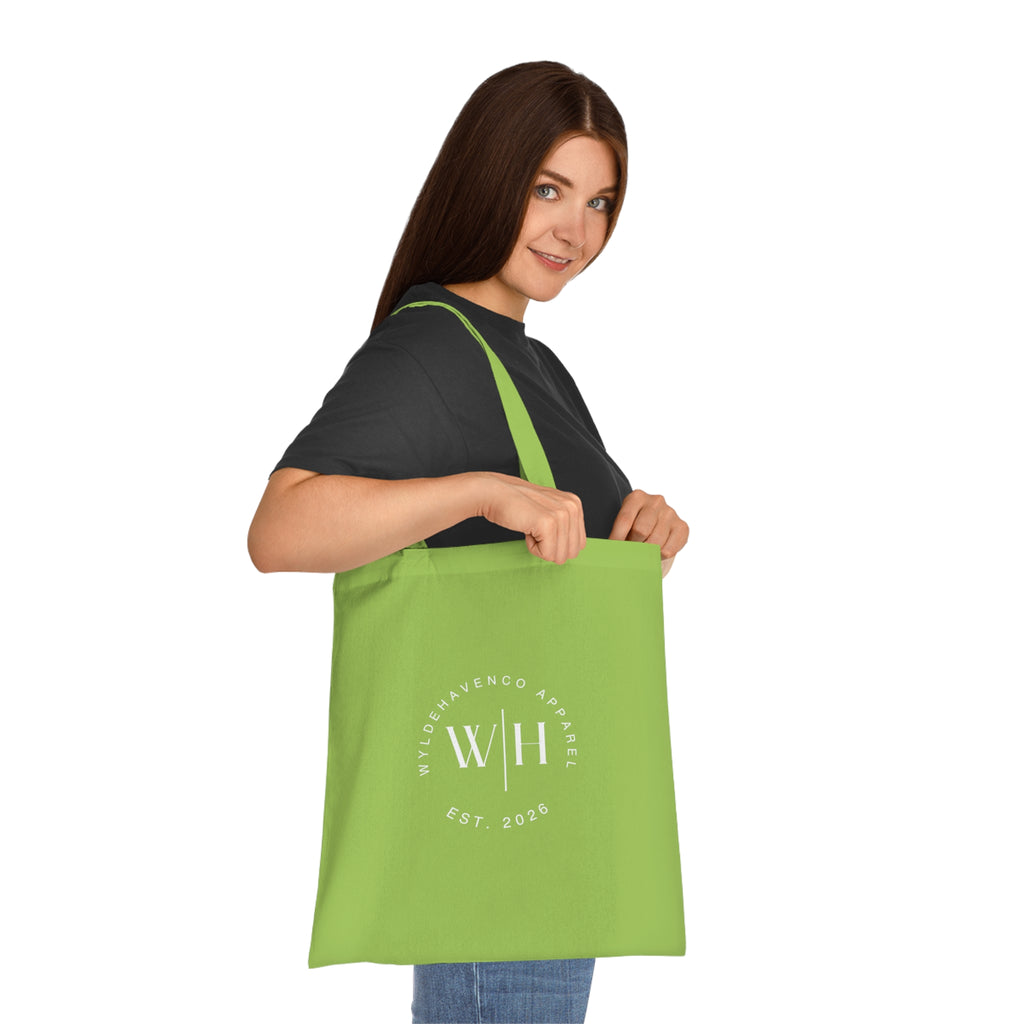 White cotton tote bag with black monogram circle and WH logo, featuring durable canvas material and sturdy handles.