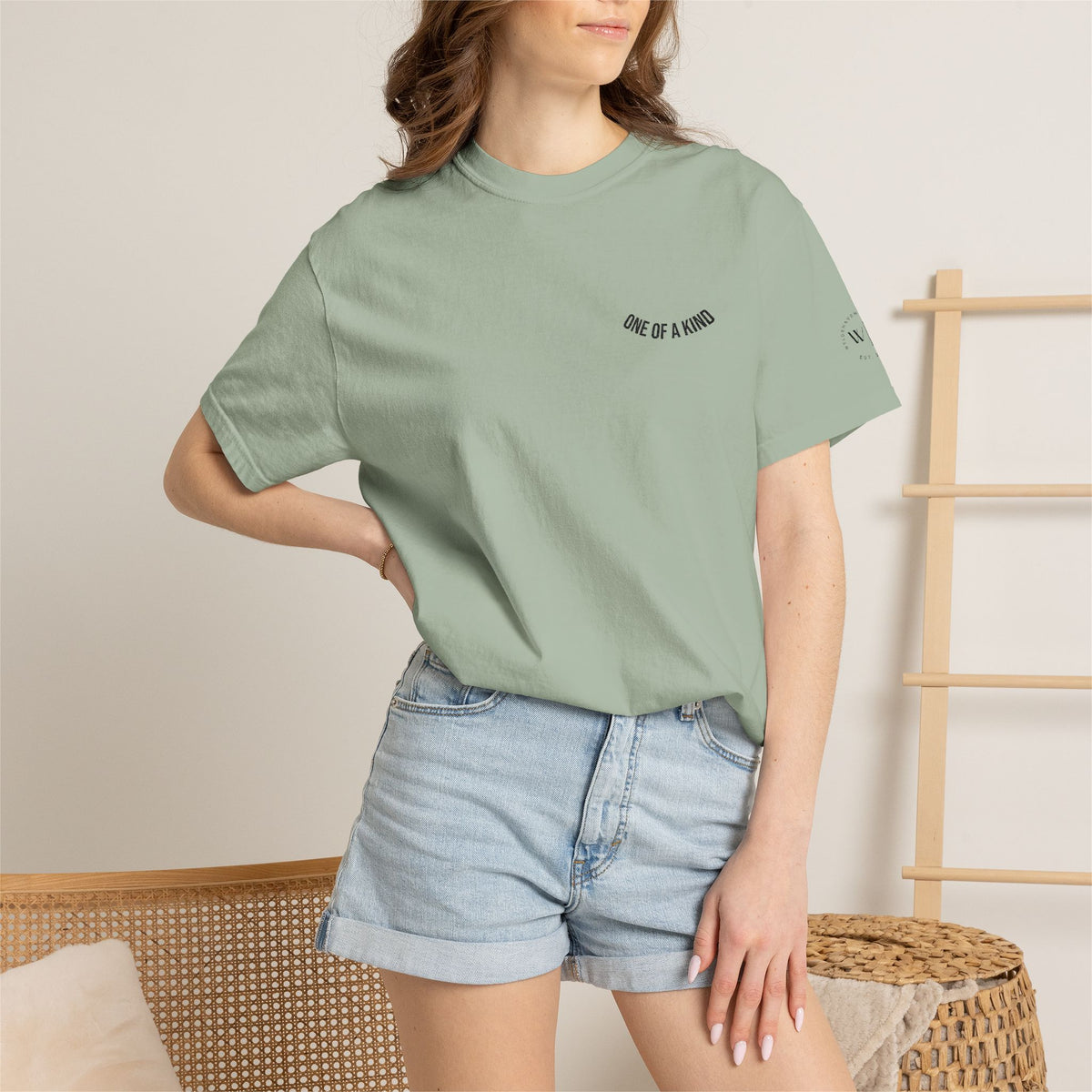 Black "One of a Kind" Chest Logo T-shirt by Printify featuring a minimalist logo on the front, made from soft cotton fabric.