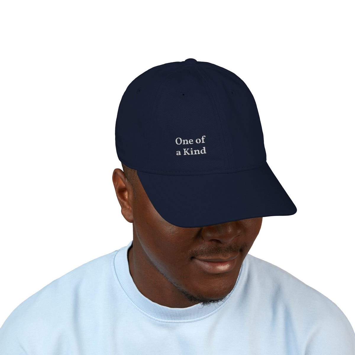 Organic embroidered baseball cap with "One of a Kind" design, casual style, featuring minimal embroidery and comfortable fit.