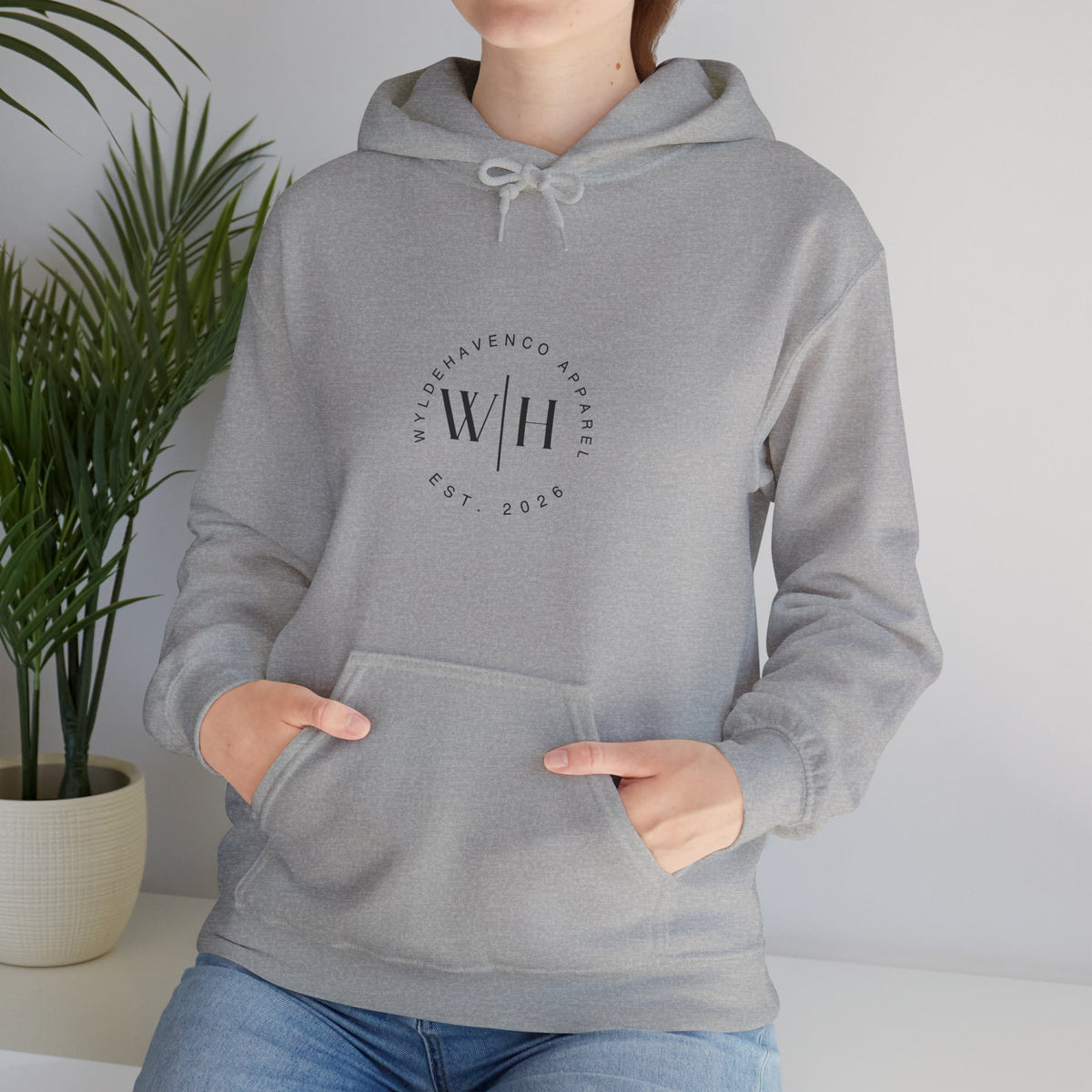 Gray Monogram Circle Hoodie by WyldeHaven Apparel featuring Est. 2026 logo and printed branding on soft sweatshirt fabric.