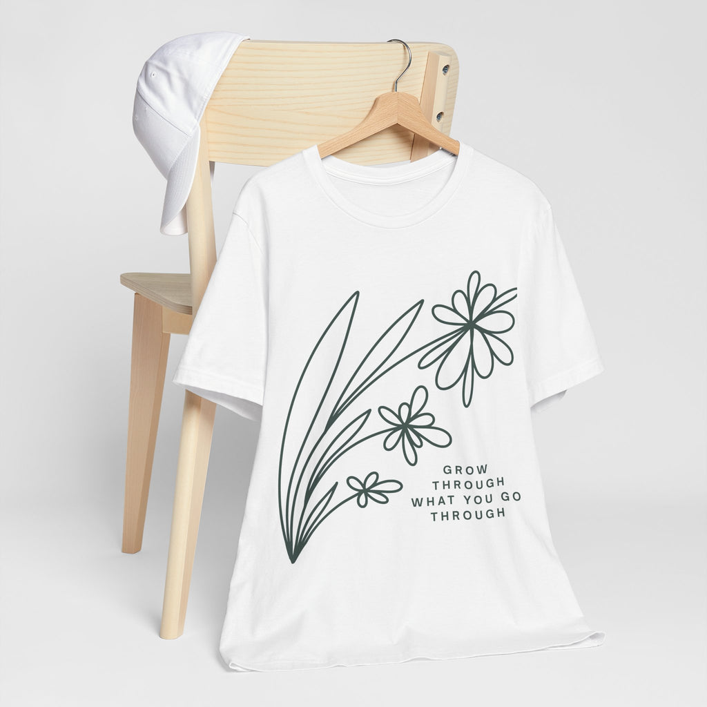 Floral inspirational graphic T-shirt with "Grow Through What You Go Through" message, designed by Printify, worn on a model.