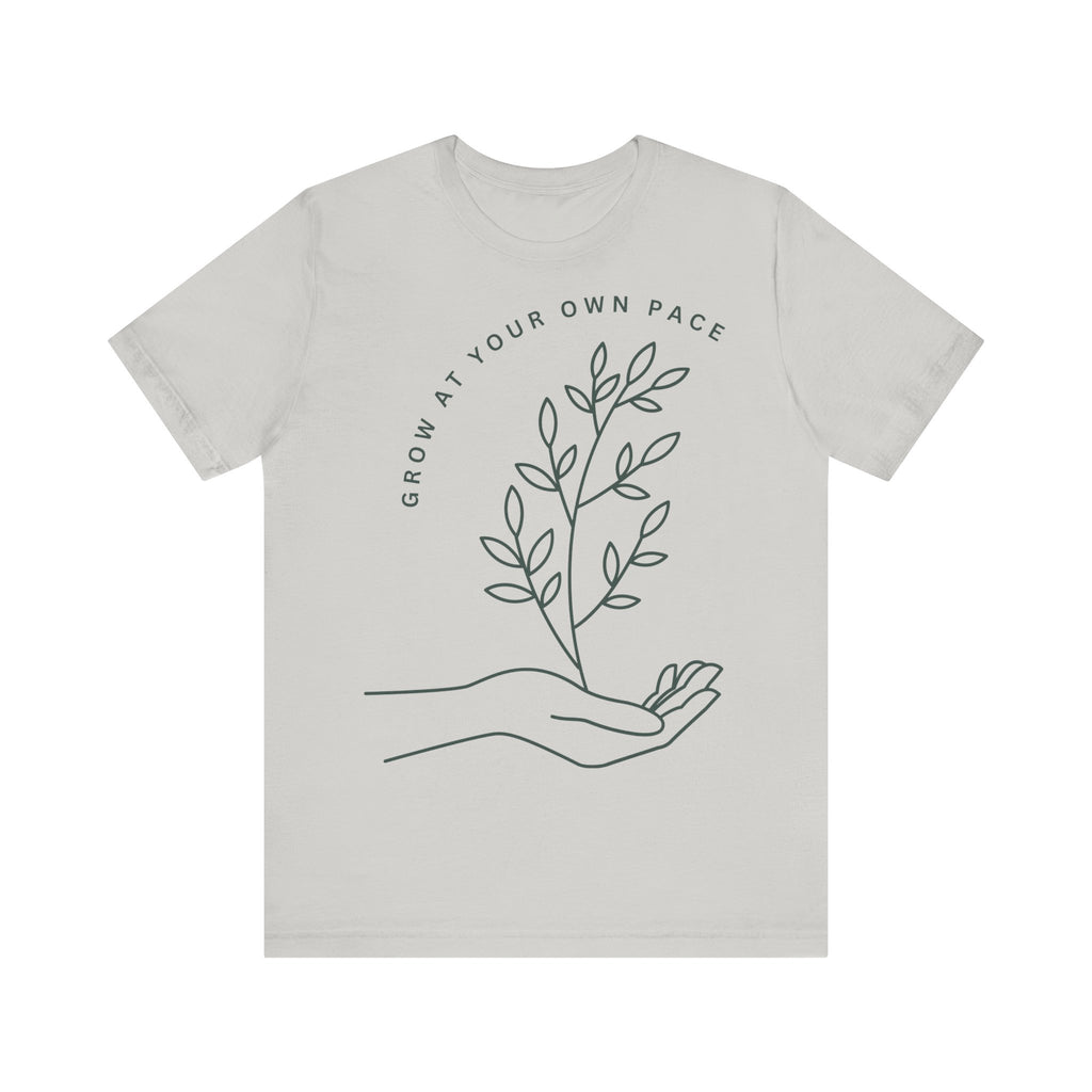 Minimal botanical print T-shirt from Printify with "Grow At Your Own Pace" slogan in soft, comfortable fabric.