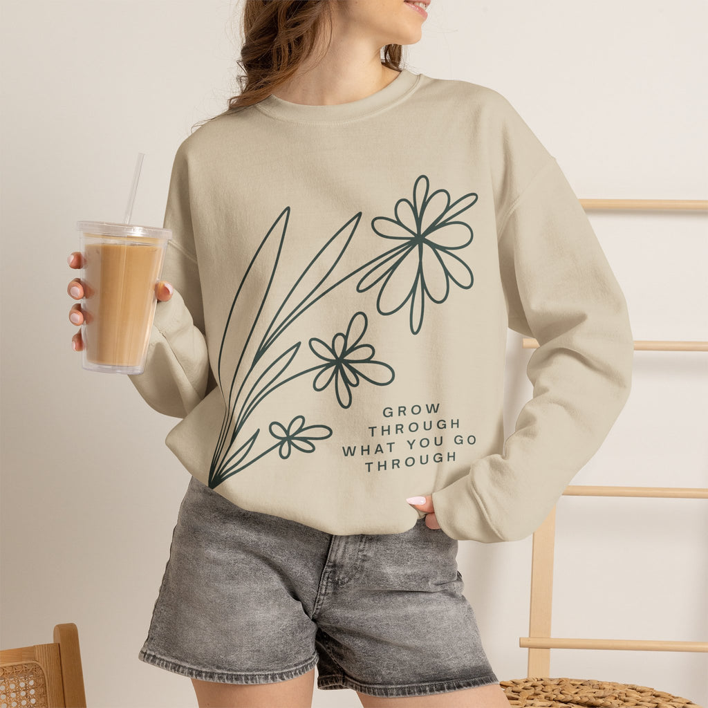 Gray crewneck sweatshirt with floral design and motivational quote "Grow Through What You Go Through" by Printify.