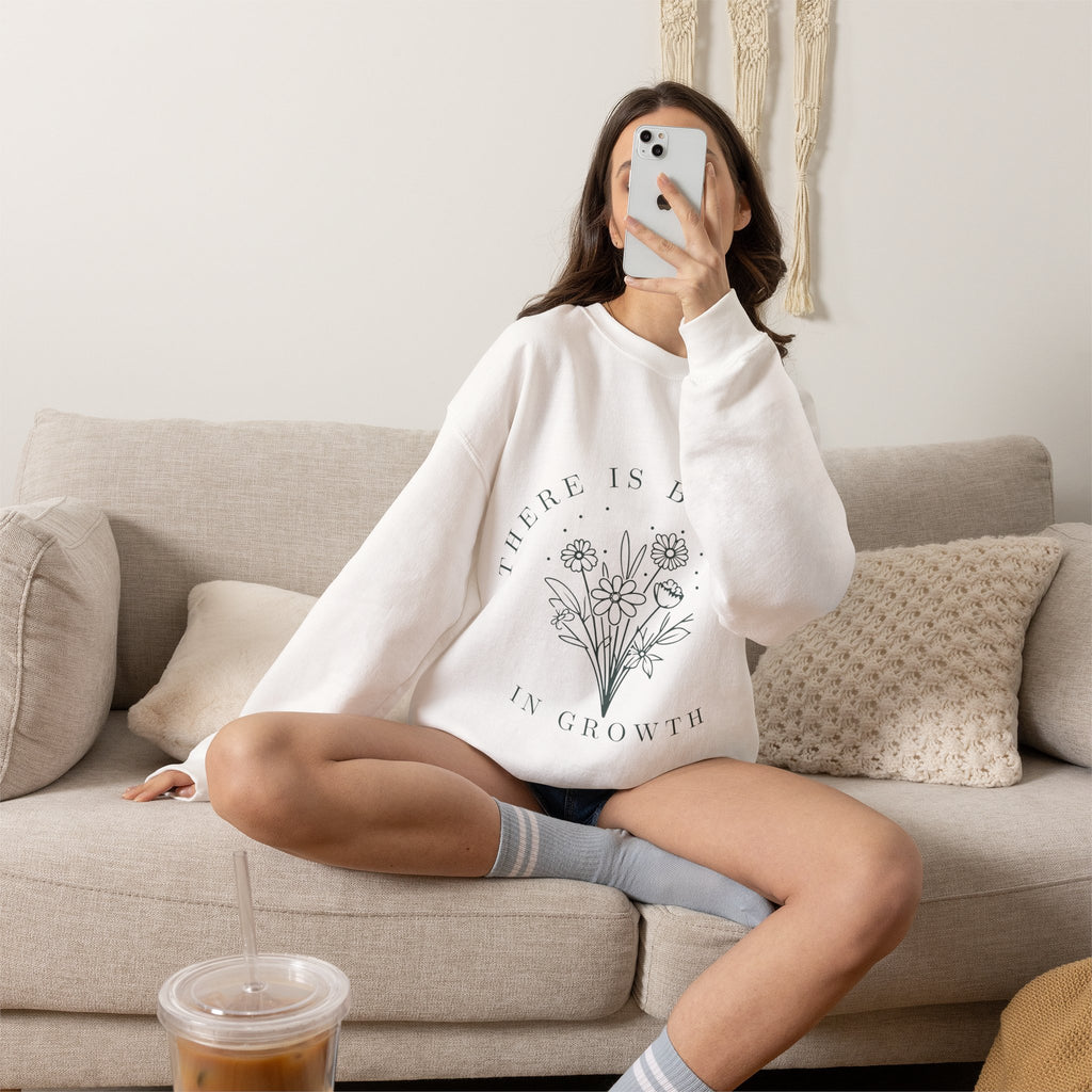 Printify crewneck sweatshirt with floral minimalist design and "There Is Beauty in Growth" quote on soft fabric.