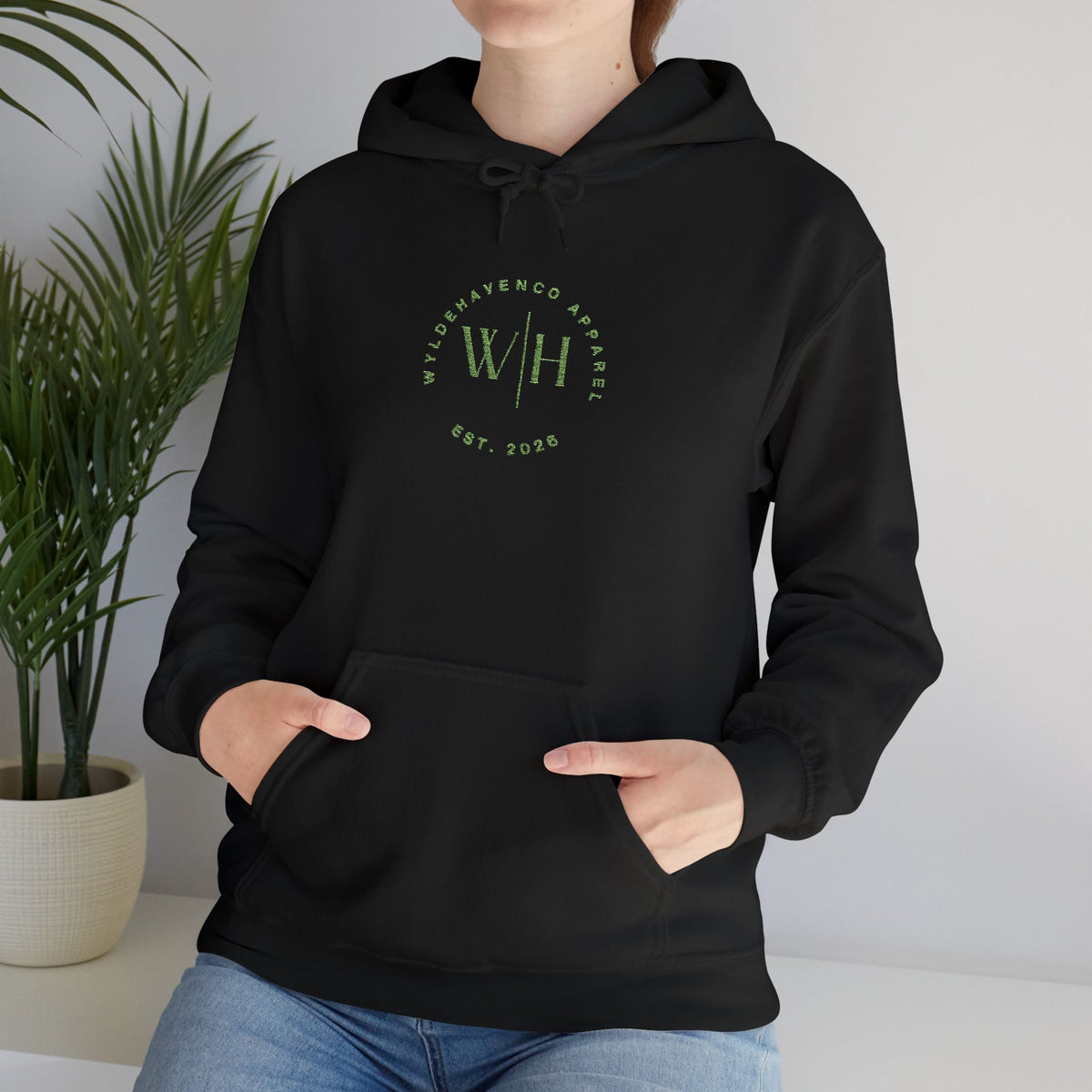 Green hoodie from Printify with WyldeHaven logo embroidery, featuring a comfortable fit and casual style.