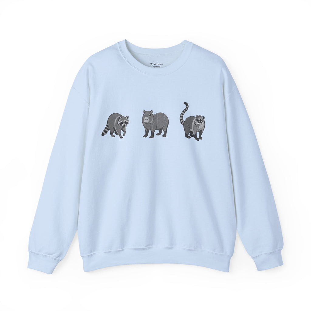 Wildlife Trio graphic sweatshirt featuring raccoon, capybara, and coati from Wyldelife Collection, with colorful animal illustrations.