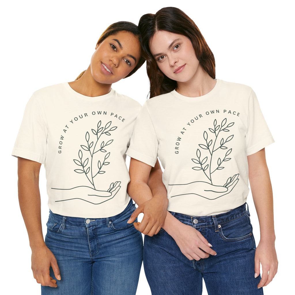 Minimal botanical T-shirt by Printify featuring "Grow At Your Own Pace" slogan on a soft cotton fabric.