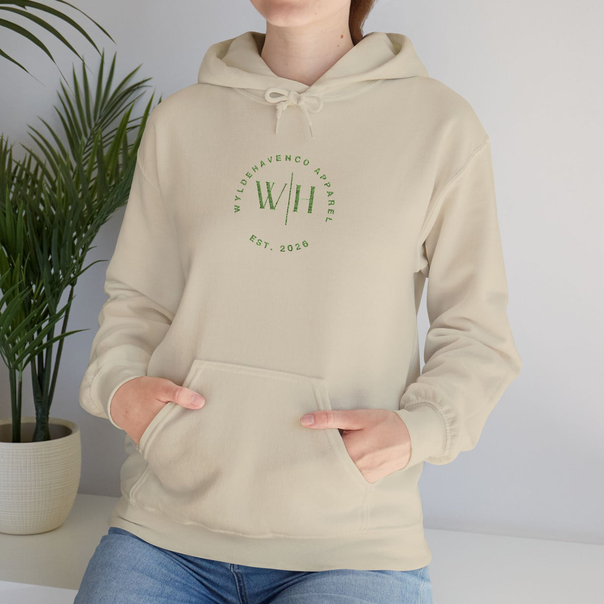 Green WyldeHaven logo embroidered hoodie by Printify, featuring a cozy fit and detailed embroidered logo on the front.