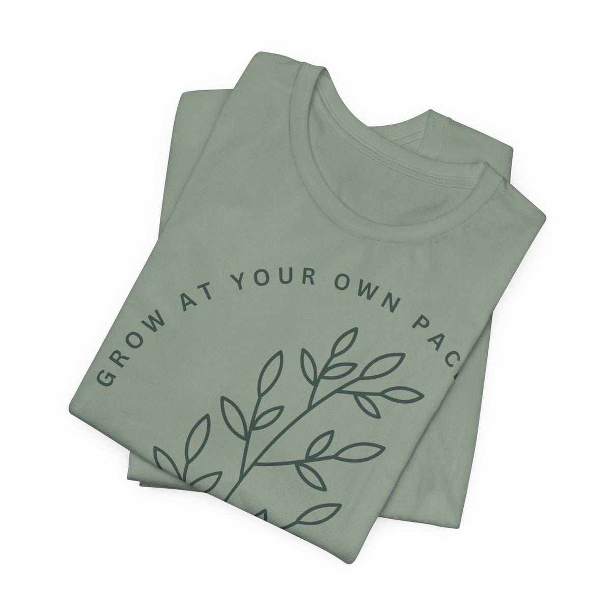 Minimal botanical T-shirt by Printify featuring "Grow At Your Own Pace" slogan and simple plant illustrations on soft fabric.