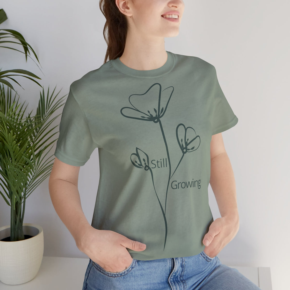 Still Growing floral-inspired minimalist T-shirt by Printify featuring a simple, inspirational design on soft fabric.